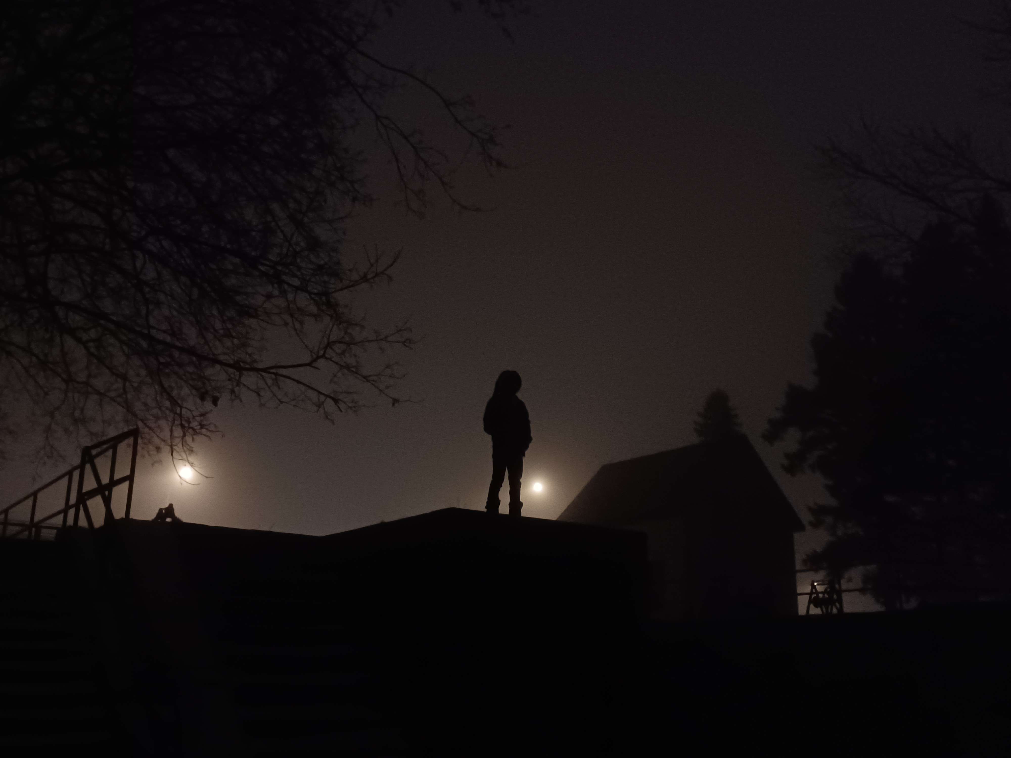 a lone figure stands infront against a great glowing